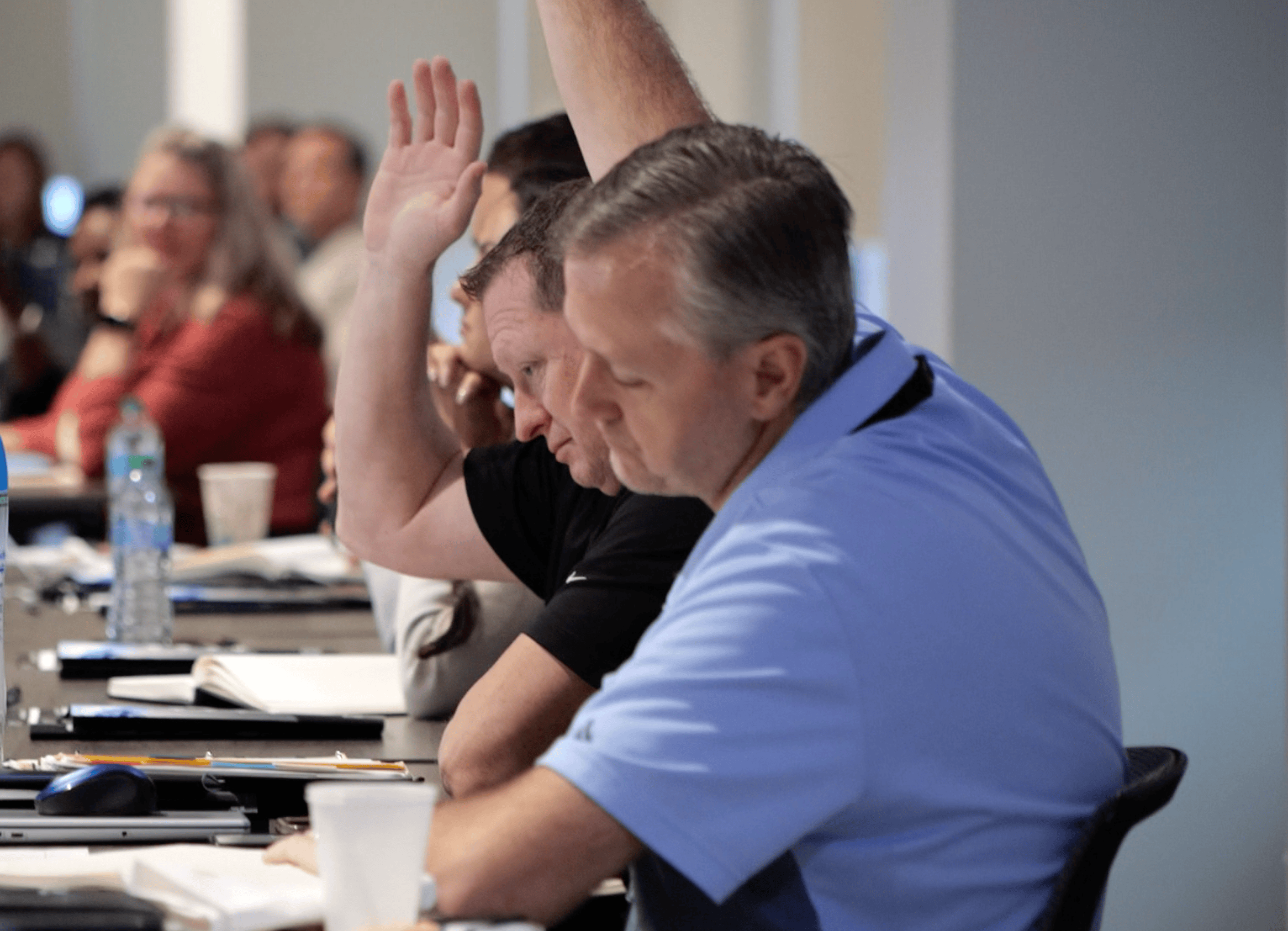 Doctors raising their hands to answer a question 